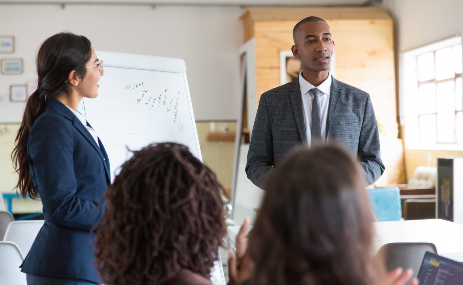 Teacher guiding students in an engaging classroom environment