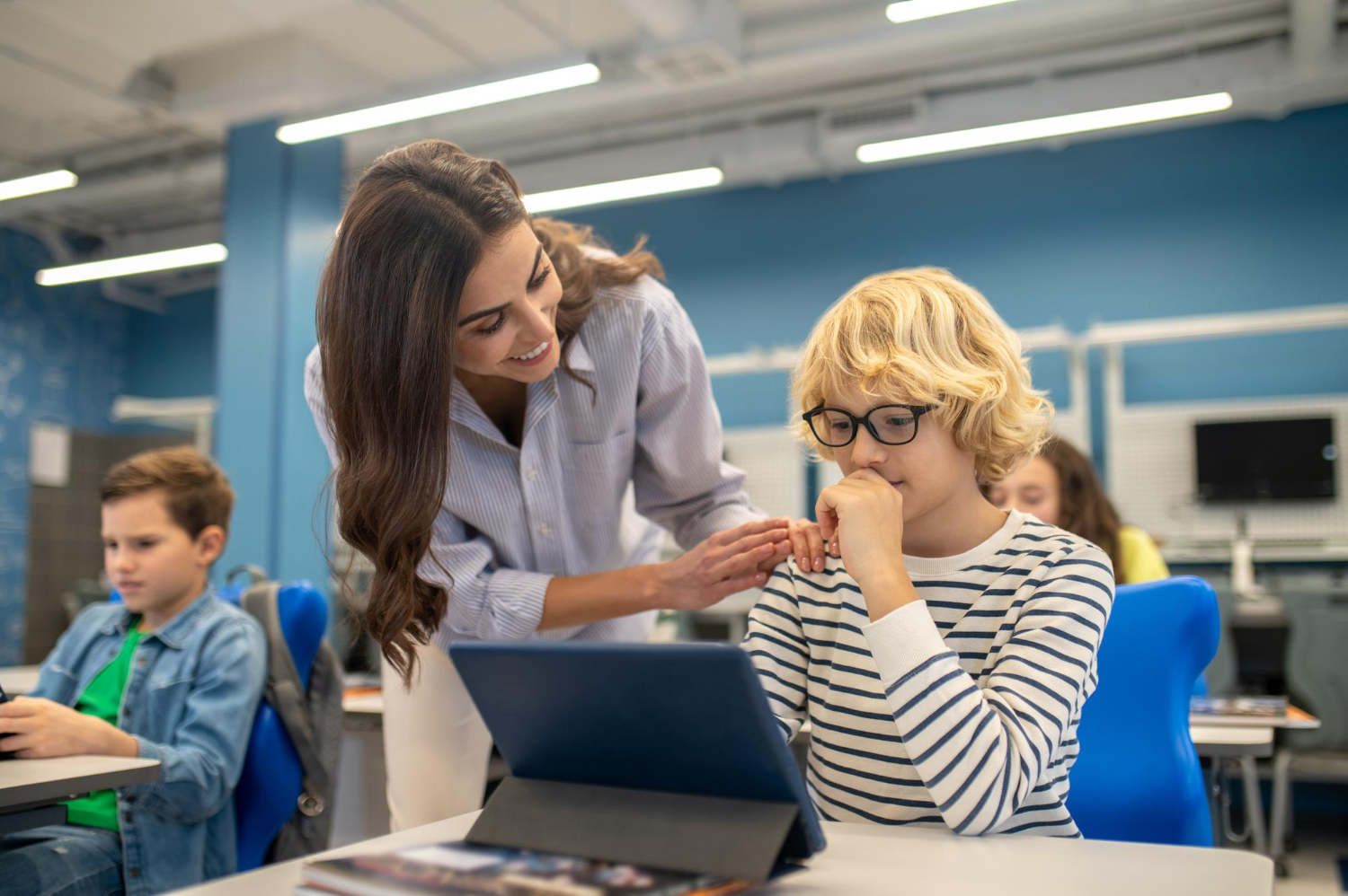 Teacher guiding students in an engaging classroom environment